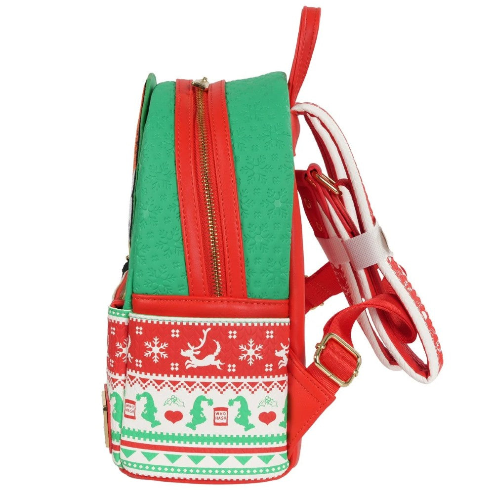 Side profile of Loungefly mini-backpack with green embossed Grinch pattern and red holiday knit design with winter motifs