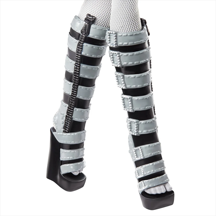 Close-up of Monster High Mattel Clawdeen Wolf doll's gray and black strappy high-heeled boots with zippers.