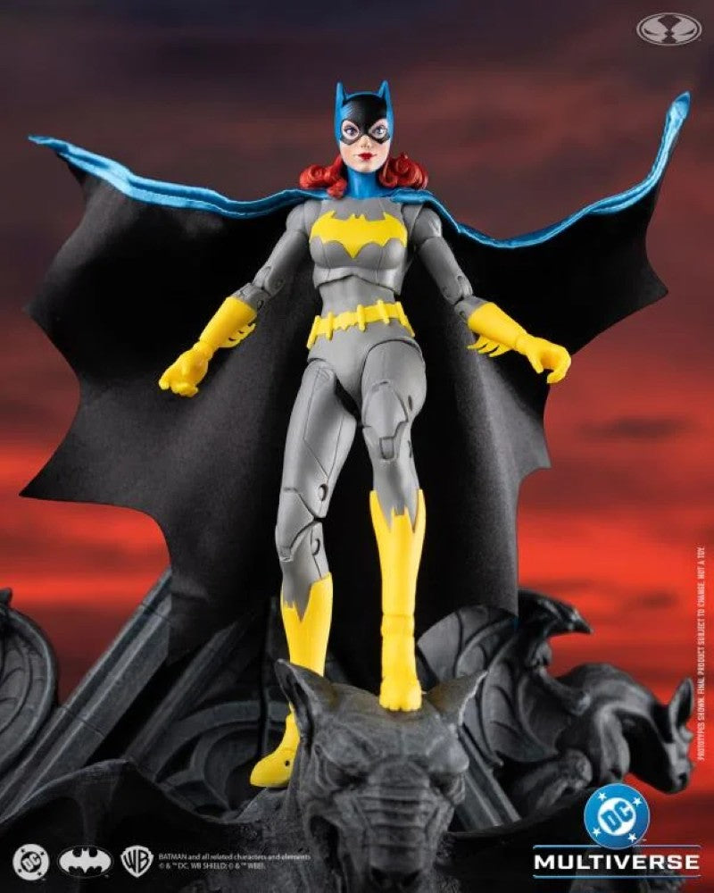 McFarlane DC Multiverse Batgirl action figure in iconic gray and yellow costume with flowing cape on a gargoyle base