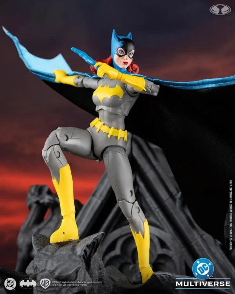 McFarlane DC Classic Batgirl action figure in dynamic pose with blue cape and yellow costume accents on rocky base