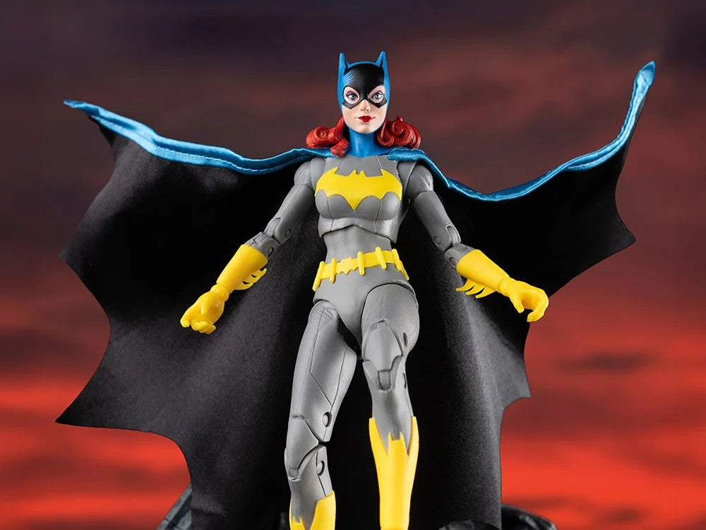 McFarlane DC Multiverse Batgirl action figure with cape in classic grey yellow costume against dark background