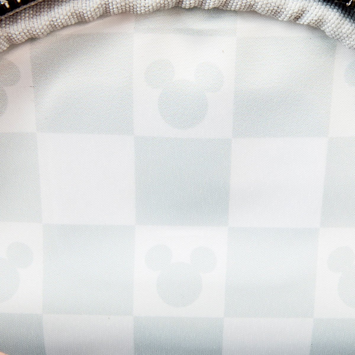Close-up of white and light gray checkerboard pattern with subtle Mickey Mouse ear silhouettes inside squares on Loungefly backpack lining