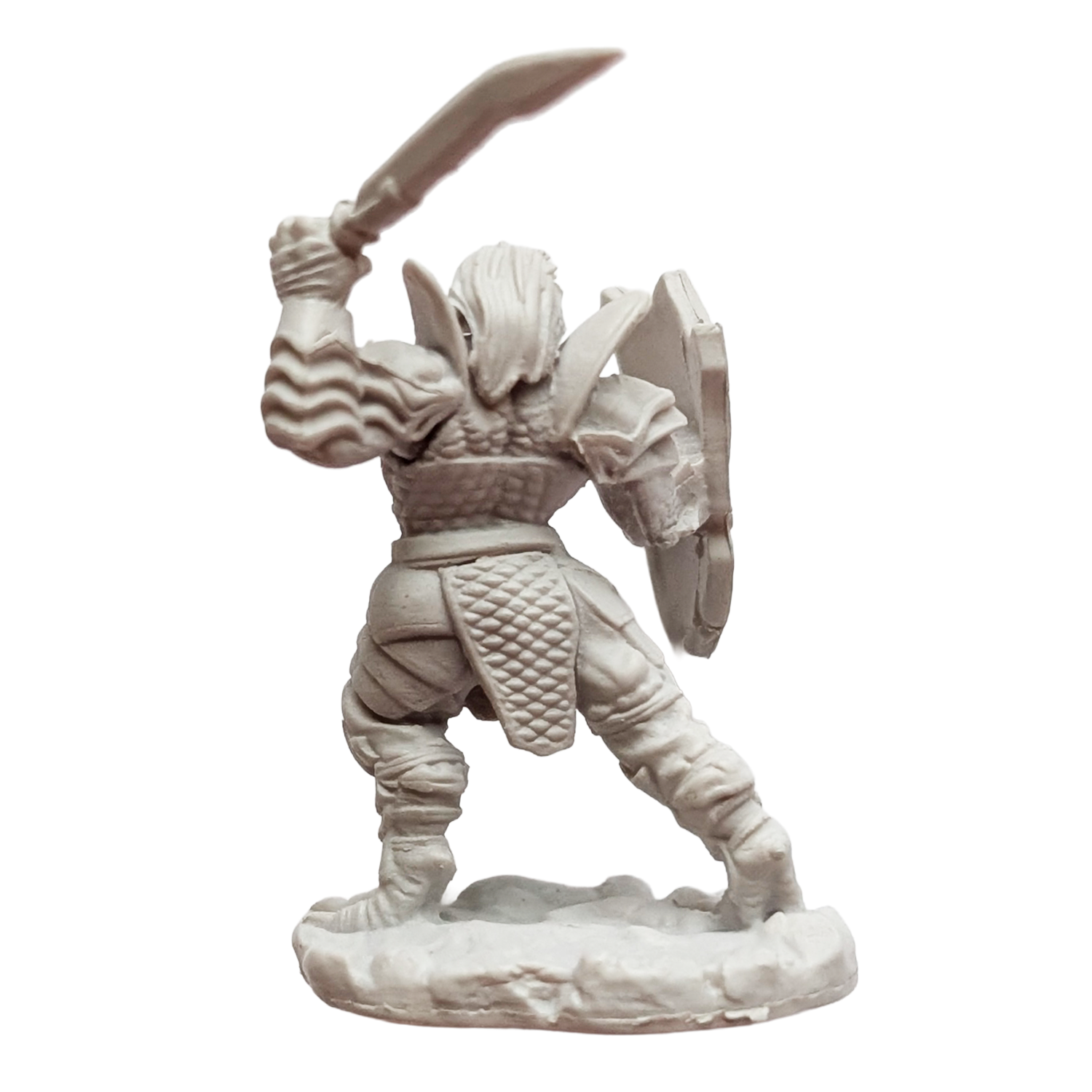 Unpainted fantasy warrior figurine wielding a sword and shield, viewed from behind