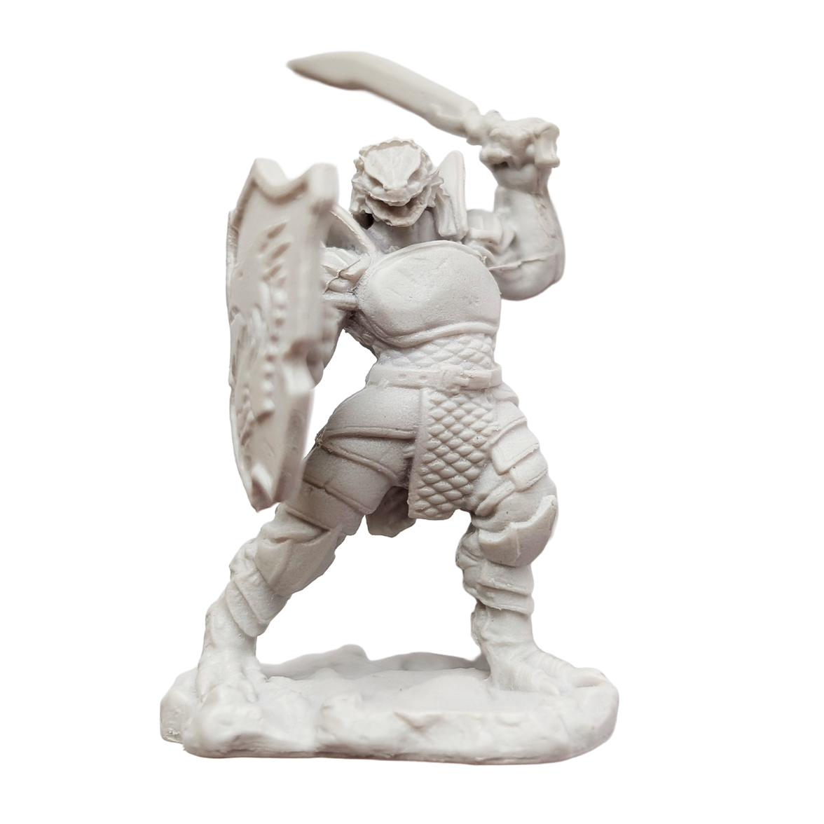 Unpainted fantasy warrior figurine holding a sword and shield on a textured base