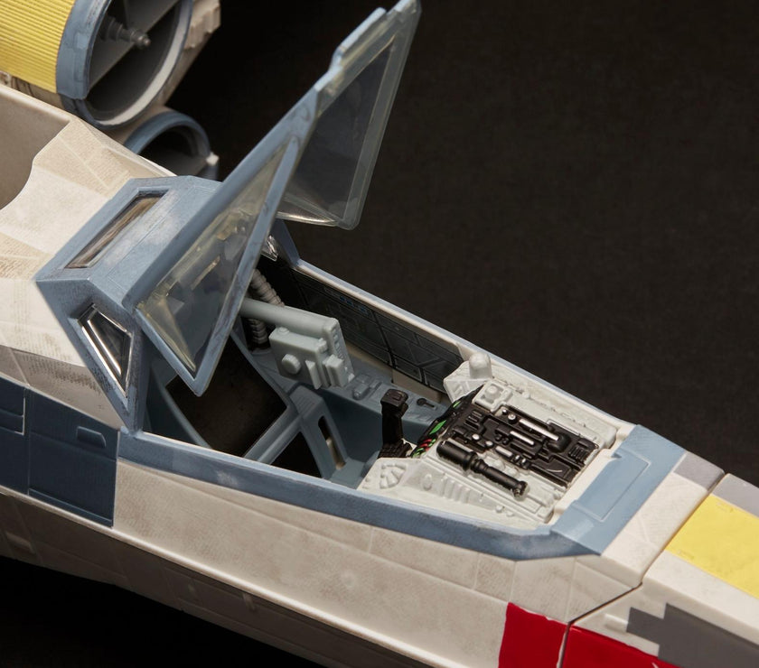 Close-up of vintage Kenner Star Wars X-Wing cockpit with open canopy and detailed interior controls.