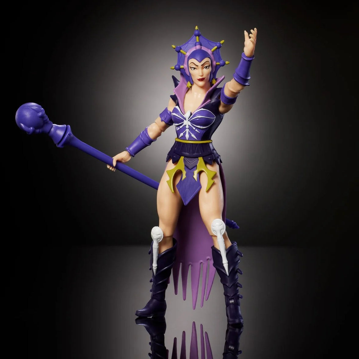 Mattel Masters of the Universe Origins 5.5-inch Evil-Lyn figure posed with purple costume and staff on black background
