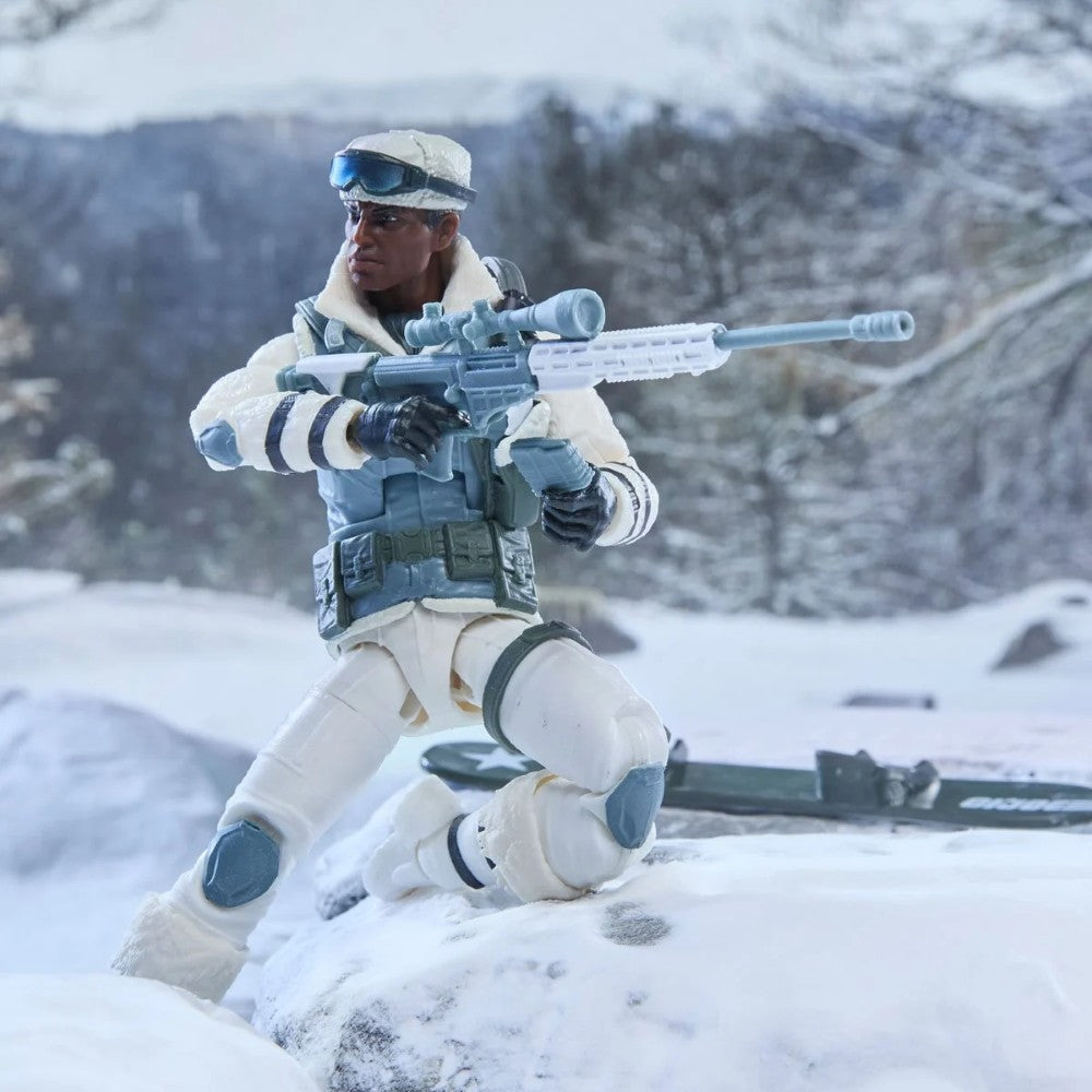 White-clad soldier action figure kneeling in snow with a scoped rifle