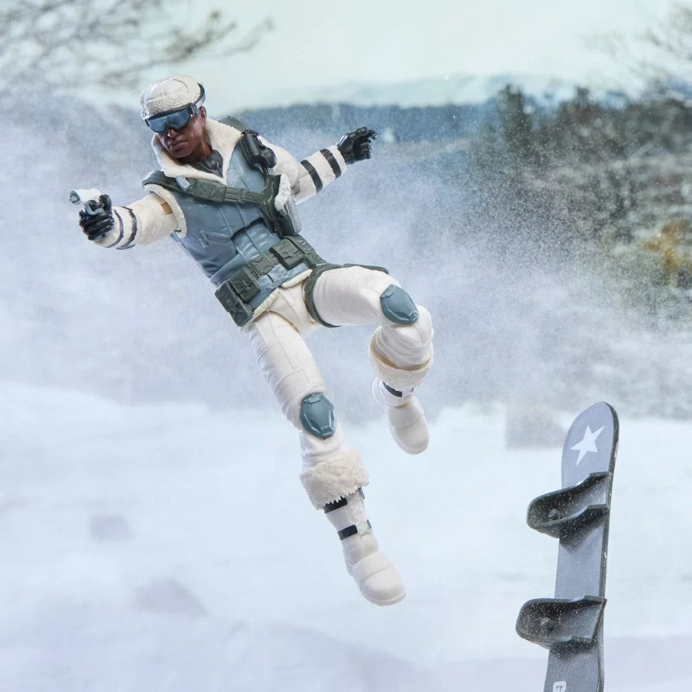Action figure in white winter gear airborne beside a ski in a snowy mountain setting