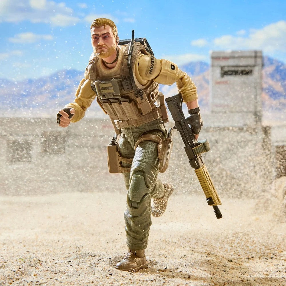 Bearded soldier action figure running across a sandy desert landscape with a rifle and tactical gear