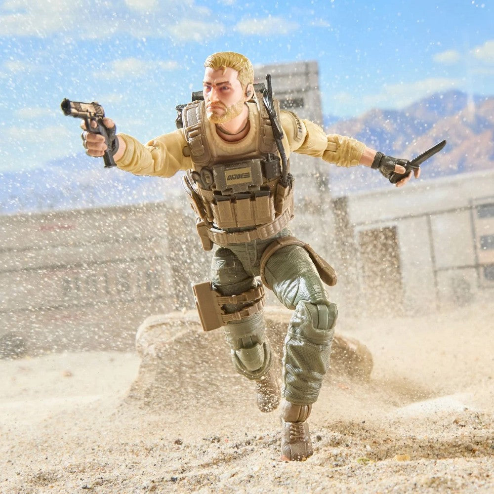 Action figure of a bearded soldier running through a sandy desert with a pistol and knife