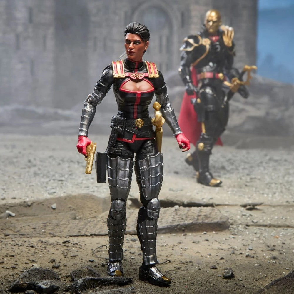 Two fantasy action figures in black and red armor standing in a ruined setting, with one figure holding a sword