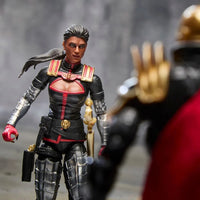 Black and red female action figure facing a blurred black and gold figure with an outstretched hand