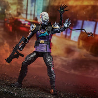 Skull-faced armored figure with white hair, purple vest, rifle, and a clawed tentacle in a city setting