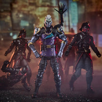Armored masked action figure leading three dark ninja figures in a moody urban setting