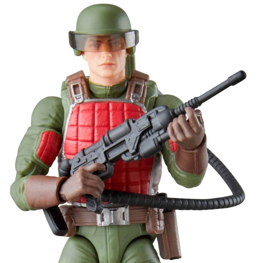 Military action figure wearing a green helmet and red body armor while holding a rifle