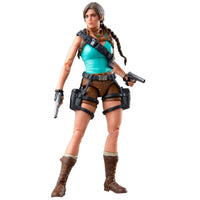 Female adventurer action figure with braided hair, turquoise top, dual pistols, holsters, and brown boots