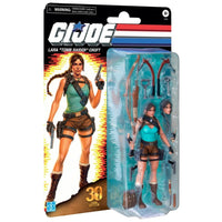 GI Joe Lara Croft figure in packaging with bows, pistols, and alternate heads