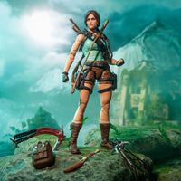 Female adventurer figure with bow and climbing gear standing on a rocky jungle ruin scene