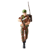 Camouflaged military action figure wearing a green cap, backpack, and boots while holding a knife
