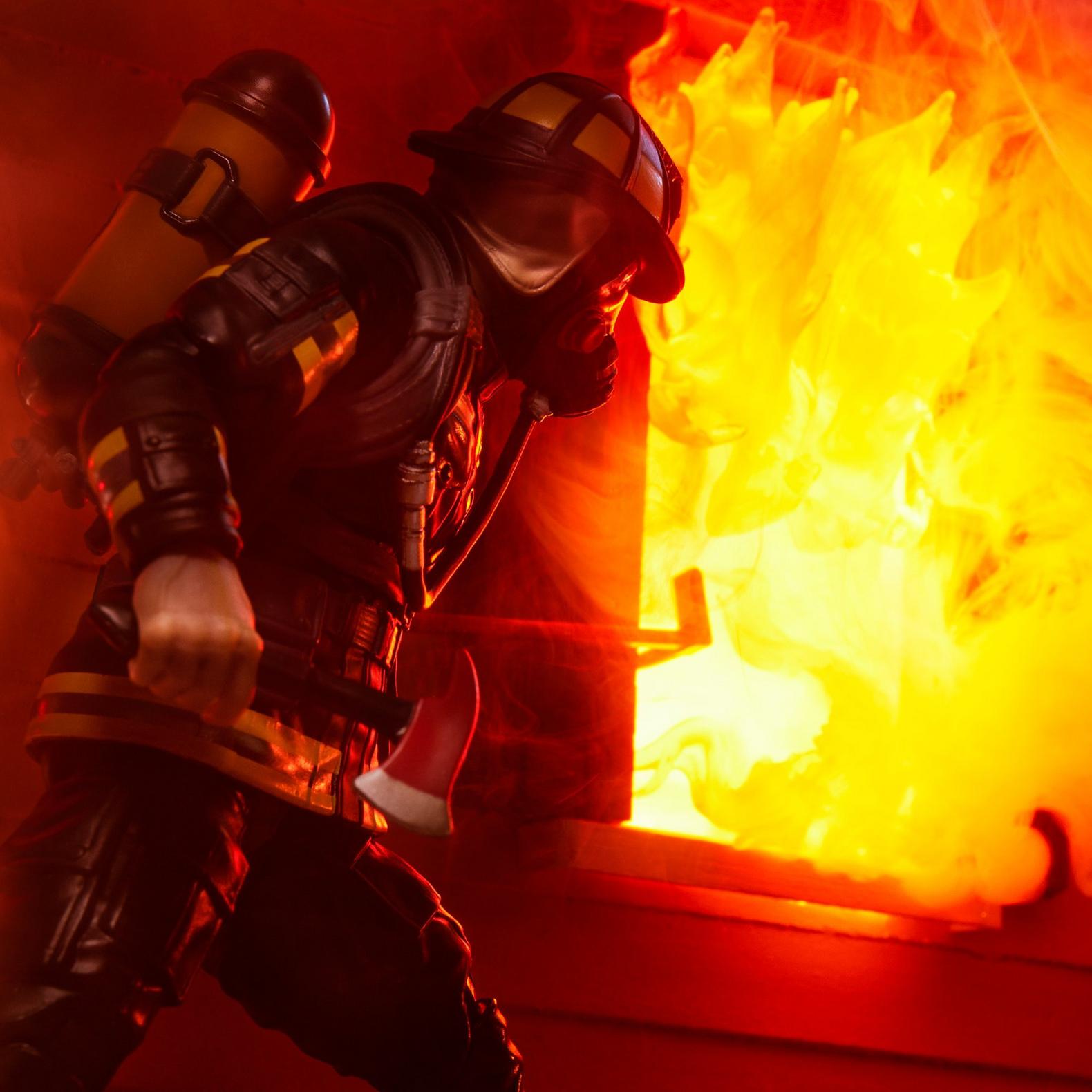 Hasbro G.I. Joe Search and Rescue Firefighter action figure in full gear battling intense flames.