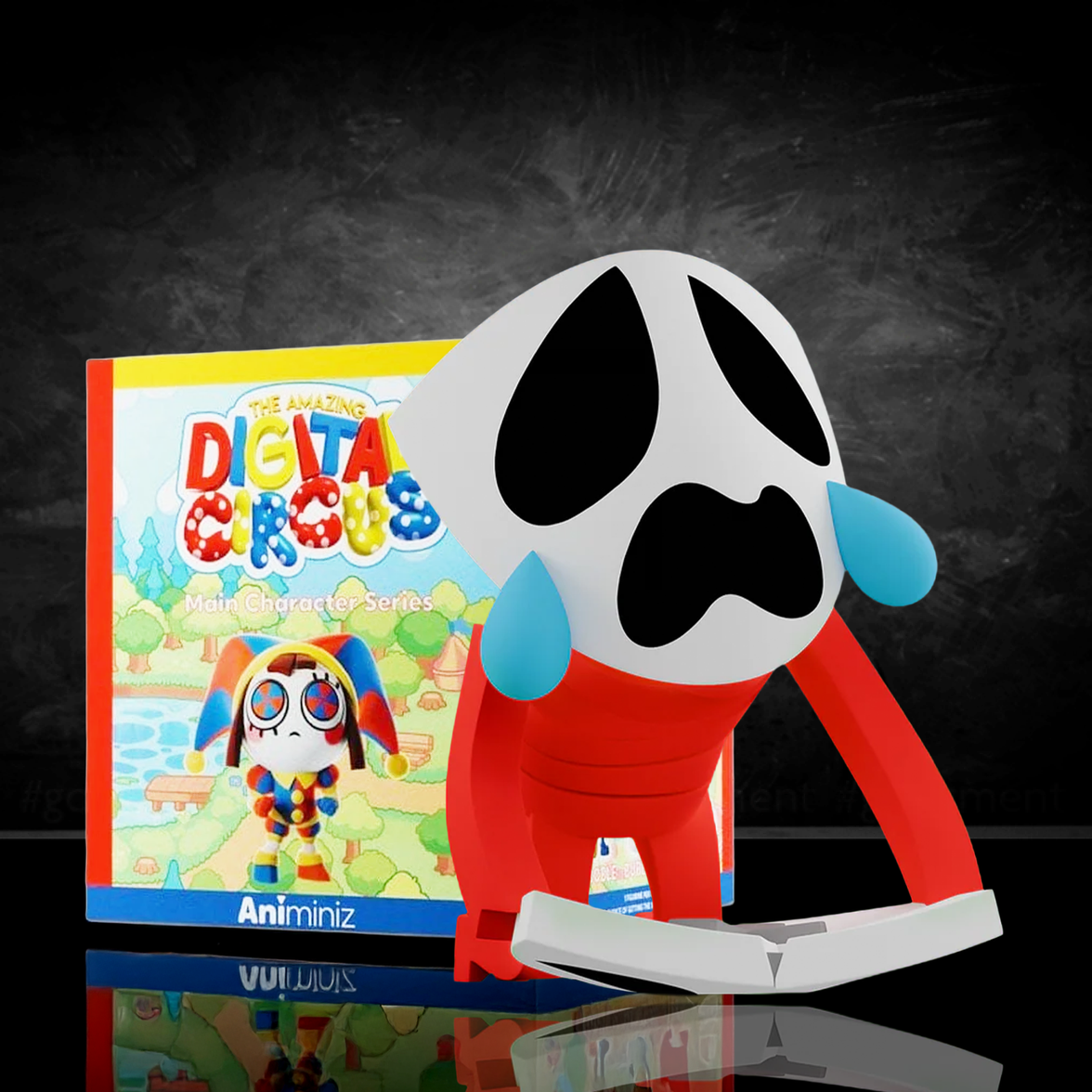 Gangle figure from Glitch’s Amazing Digital Circus Animiniz Main Characters Series with sad mask and red body against dark background