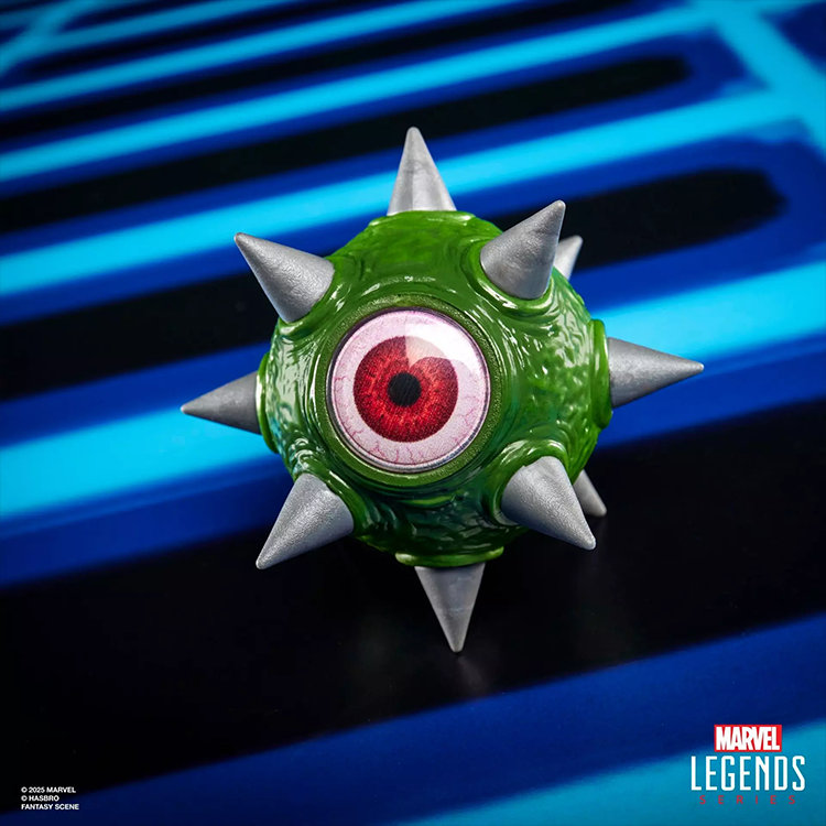 Close-up of Marvel Legends Gamerverse Gargantos non-articulated spiked eyeball accessory on blue arcade-themed background