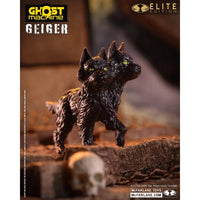 Two-headed black cat creature figure on a tree branch with a skull and Ghost Machine Geiger Elite Edition branding