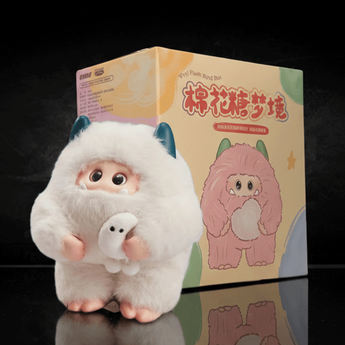 OHKU Giggle Monster Marshmallow Dreams white vinyl plush with teal horns holding small ghost figure beside colorful box
