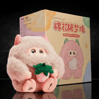 OHKU Giggle Monster Marshmallow Dreams plush with soft fur holding a pink strawberry in front of colorful box packaging