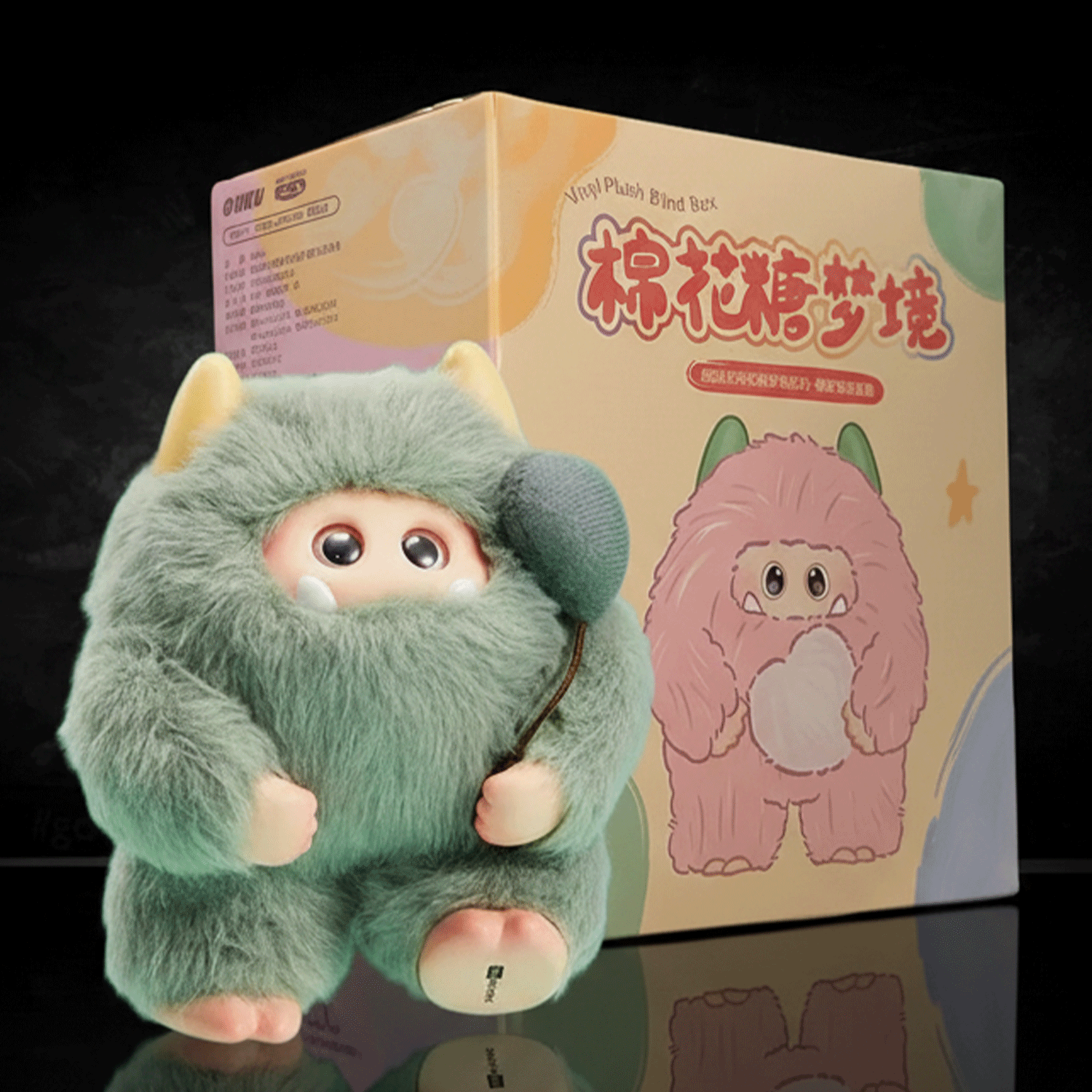 OHKU Giggle Monster Marshmallow Dreams green plush with hidden eyes and soft horns beside illustrated blind-box packaging