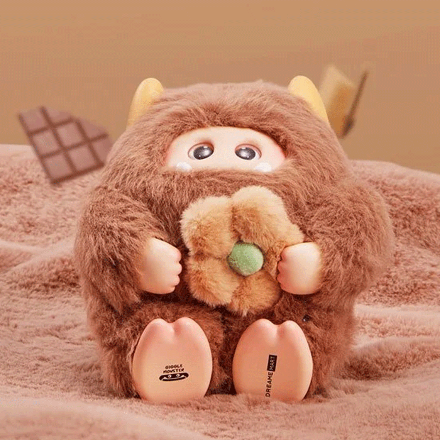 OHKU Giggle Monster Marshmallow Dreams brown vinyl plush holding fuzzy flower with playful eyes peeking through fur