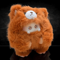 OHKU Giggle Monster vinyl plush in fluffy bright orange bear-inspired costume with sparkling eyes on black background