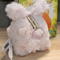 OHKU Giggle Monster Furry Forest plush figure in pale pink fluffy costume with keychain ring on wooden surface