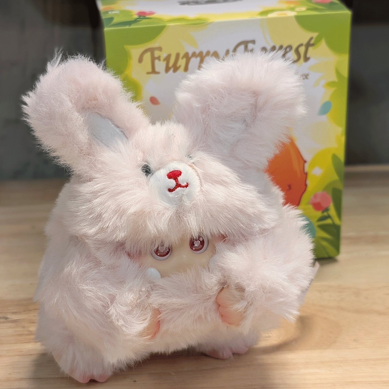 OHKU Giggle Monster Furry Forest plush figure in fluffy bunny-inspired costume with soft fur on wooden surface