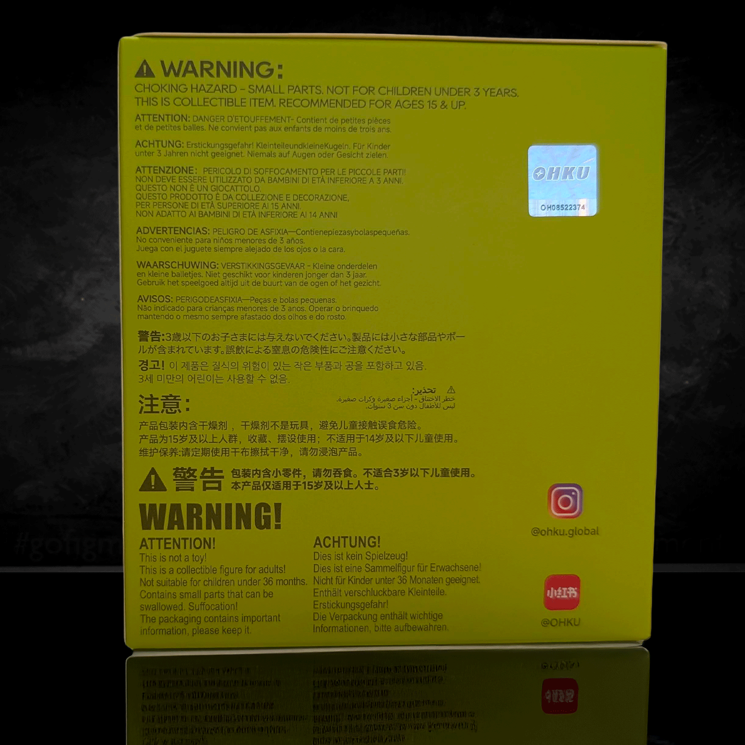 OHKU Giggle Monster blind box packaging with multilingual safety warnings and collector information on yellow background