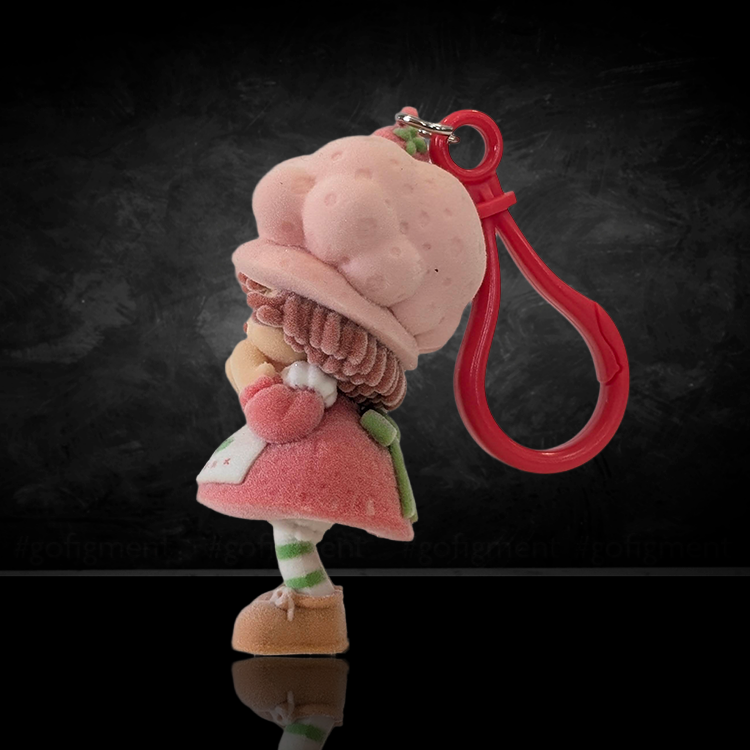 UCC World of Strawberry Shortcake flocked mini figure clip wearing pink hat and red clip attachment facing sideways