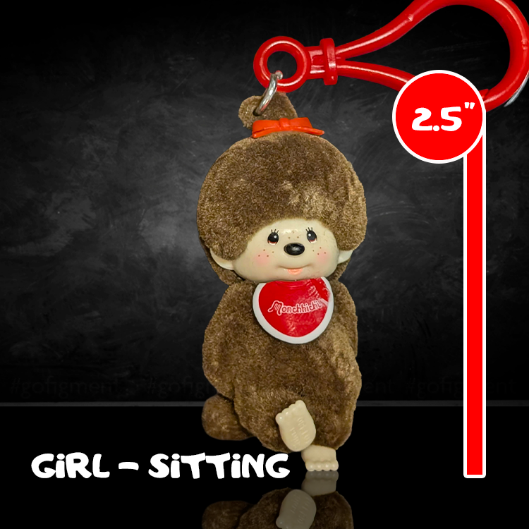 Sekiguchi Monchhichi 2.5 inch sitting girl figure with brown flocked vinyl and red clip on dark background