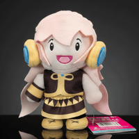 Front view of UCC 6-inch Megurine Luka plush with pink hair, yellow headphones, and detailed brown outfit standing on black surface