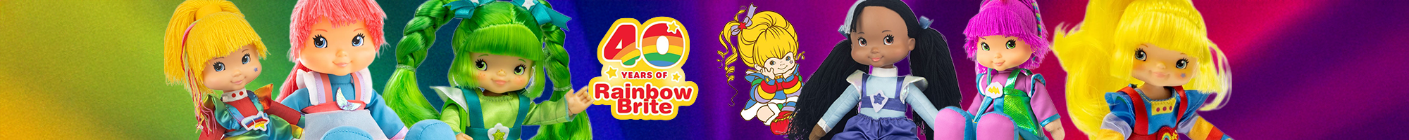 Rainbow Brite 40th Anniversary collection featuring seven colorful dolls standing in a row on a rainbow background