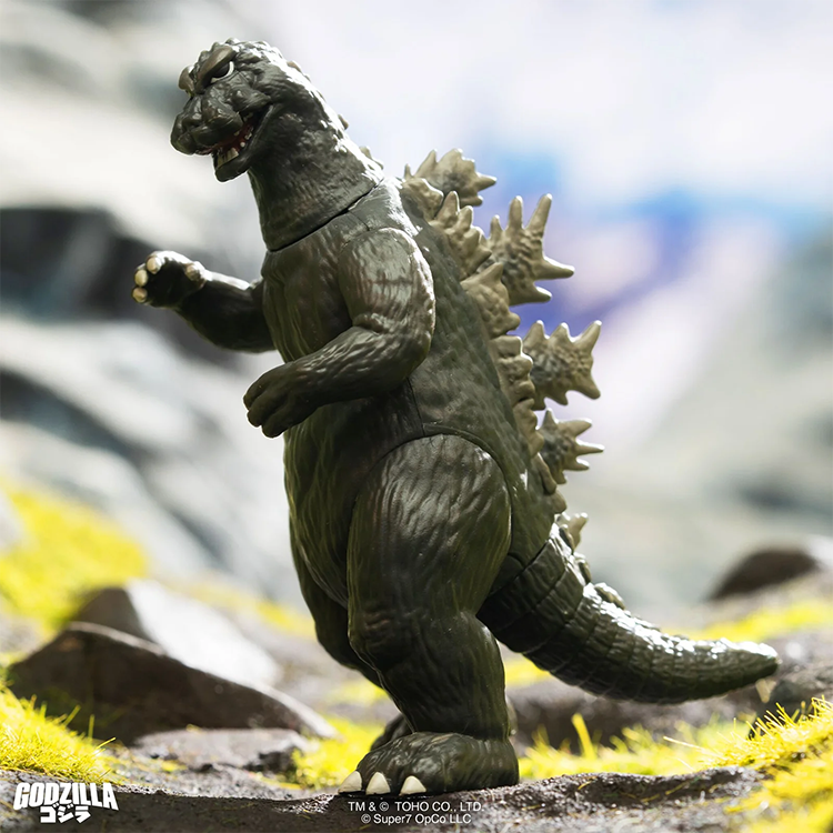 Super7 Godzilla 1964 ReAction figure posed outdoors with detailed sculpt and iconic spines in natural light.