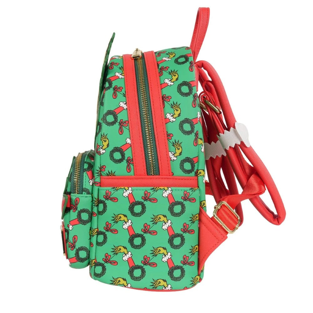 Loungefly mini-backpack side view with green Grinch wreath pattern and bright red adjustable straps and zipper pulls