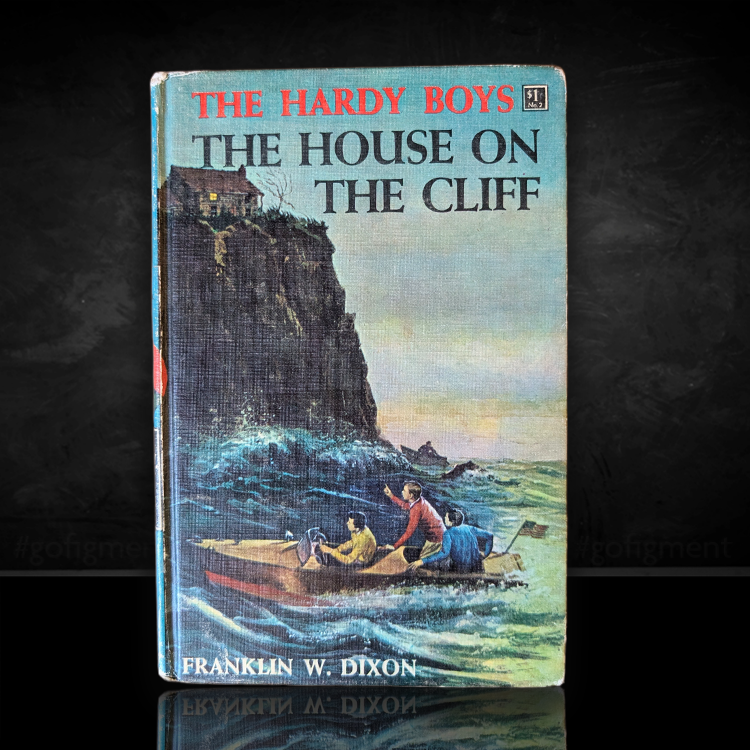 Vintage 1959 edition of The Hardy Boys The House on the Cliff with cliffside house and boat scene on cover