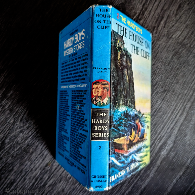 Vintage 1959 edition of The Hardy Boys 02 The House on the Cliff with blue cover by Grosset & Dunlap