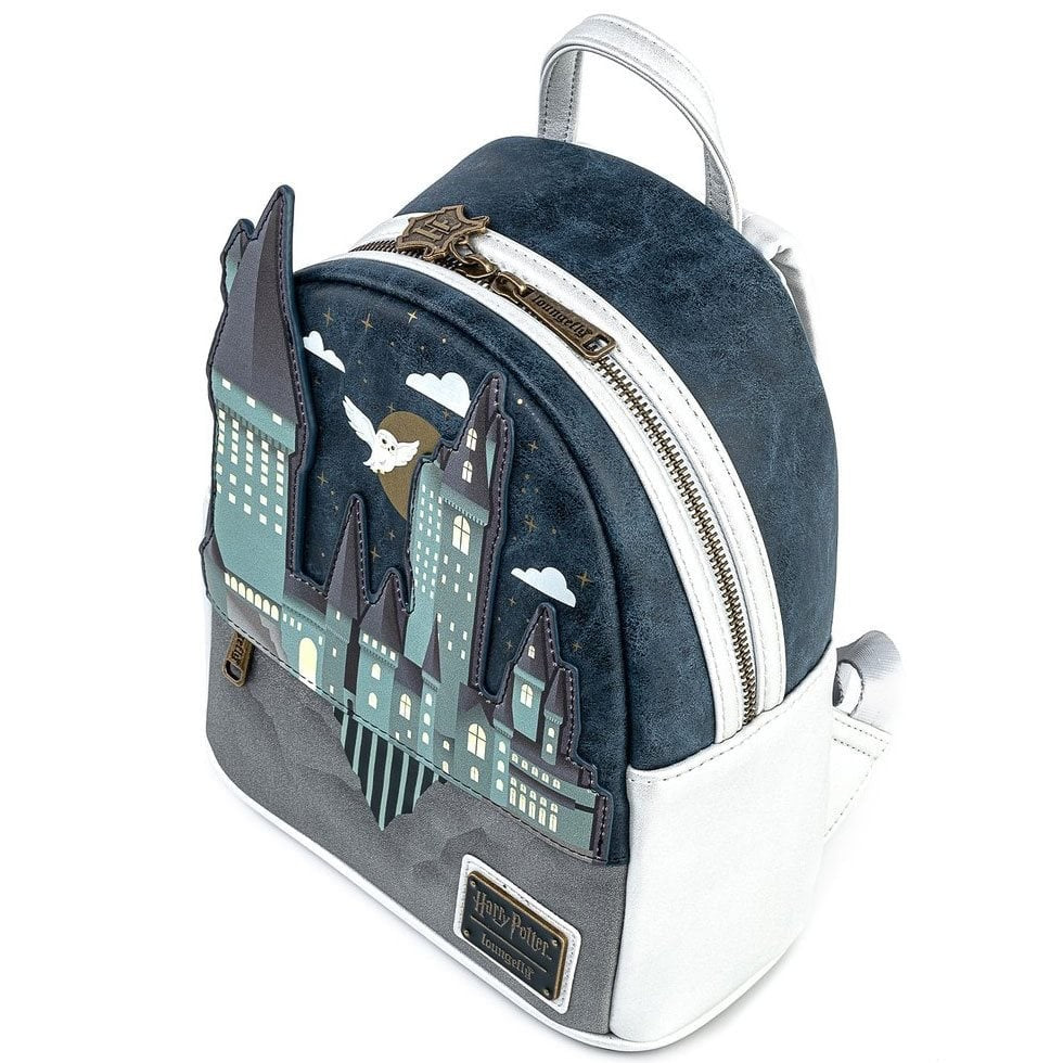 Loungefly mini-backpack showcasing Hogwarts Castle silhouette with flying owl against navy blue and gray suede background