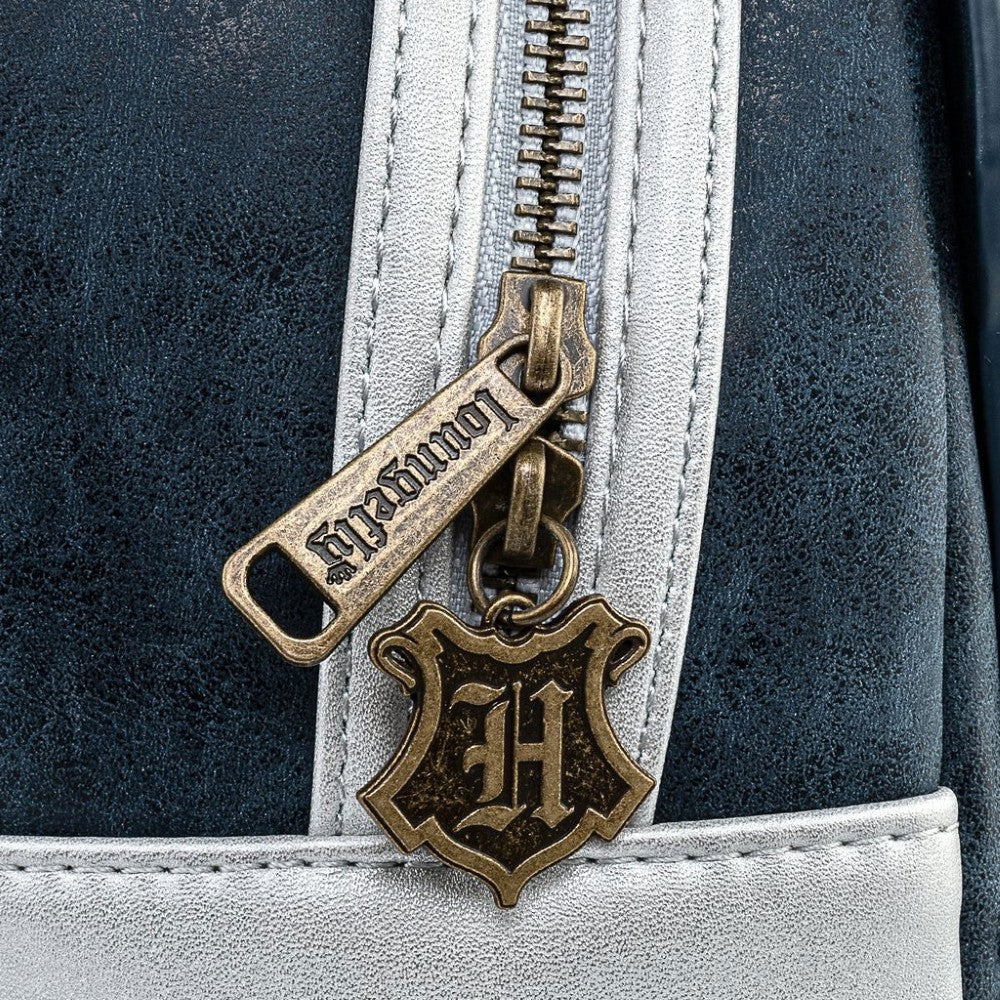 Close-up of Loungefly zipper pull with Hogwarts crest charm on black and silver Harry Potter mini-backpack