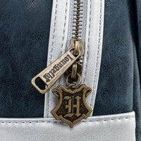 Close-up of Loungefly zipper pull with Hogwarts crest charm on black and silver Harry Potter mini-backpack