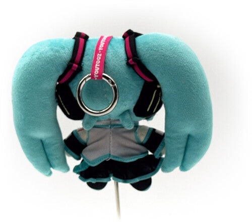Turquoise-haired plush character with long twin tails, gray outfit, black harness, and pink accents