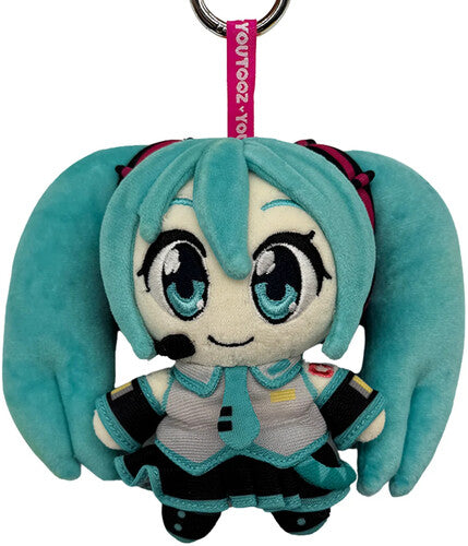 Hatsune Miku plush character with turquoise twin tails and a pink keychain strap