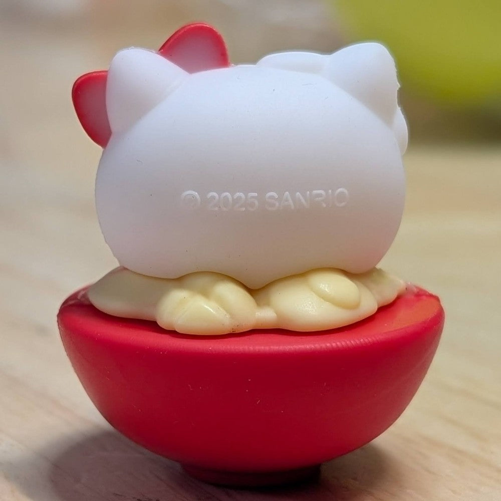 Go Figment collectible showing Hello Kitty character from behind sitting on red bowl base with cream detail