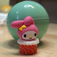 Go Figment Hello Kitty and Friends collectible capsule featuring My Melody character on sushi base with pink hood and yellow bow